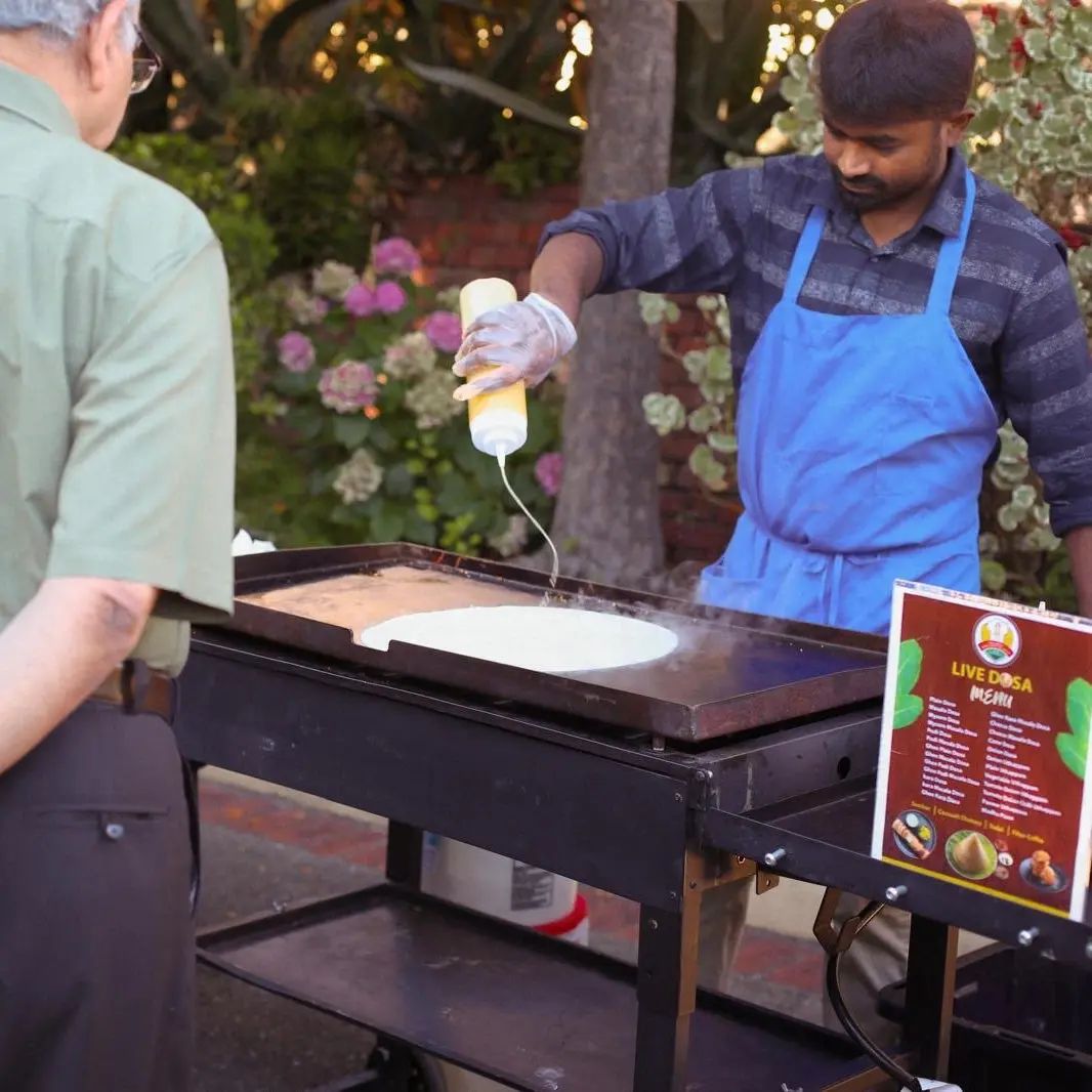 Chef preparing fresh dosa at Madhu Idiyappa Kadai